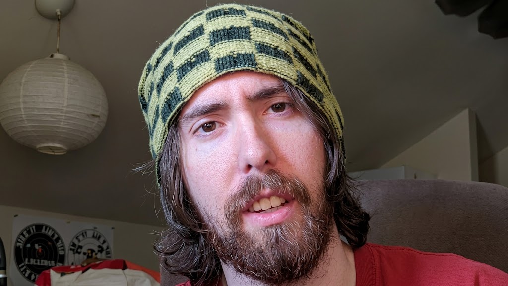 Male streamer wearing a knit cap during a livestream