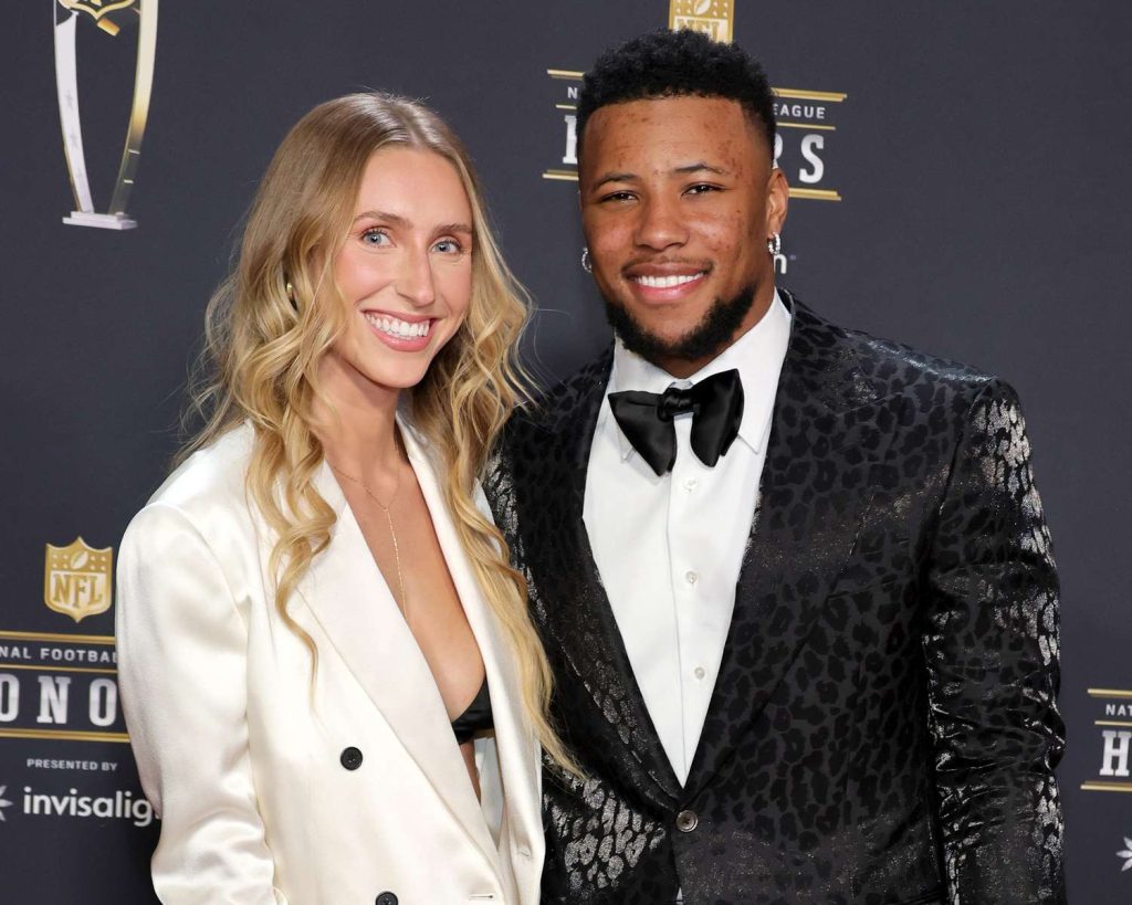 Saquon Barkley posing with fiancée Anna Congdon at a formal event
